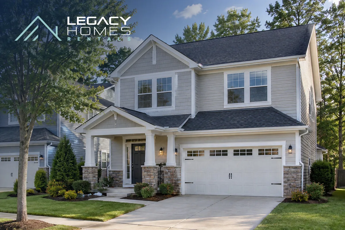 A two-story single-family home with a stone-accented porch, a two-car garage and a landscaped front lawn